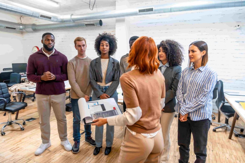 Corporate executives meet in a boardroom to discuss strategic initiatives and improvements to their insurance claims platform.
